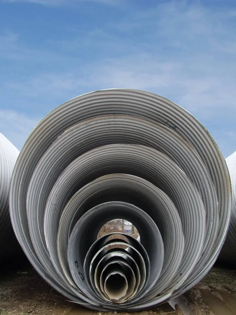 Galvanized pipe of several diameters nested inside one another, seen from the end